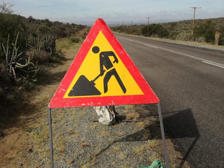 This image has an empty alt attribute; its file name is Men-at-work.jpg